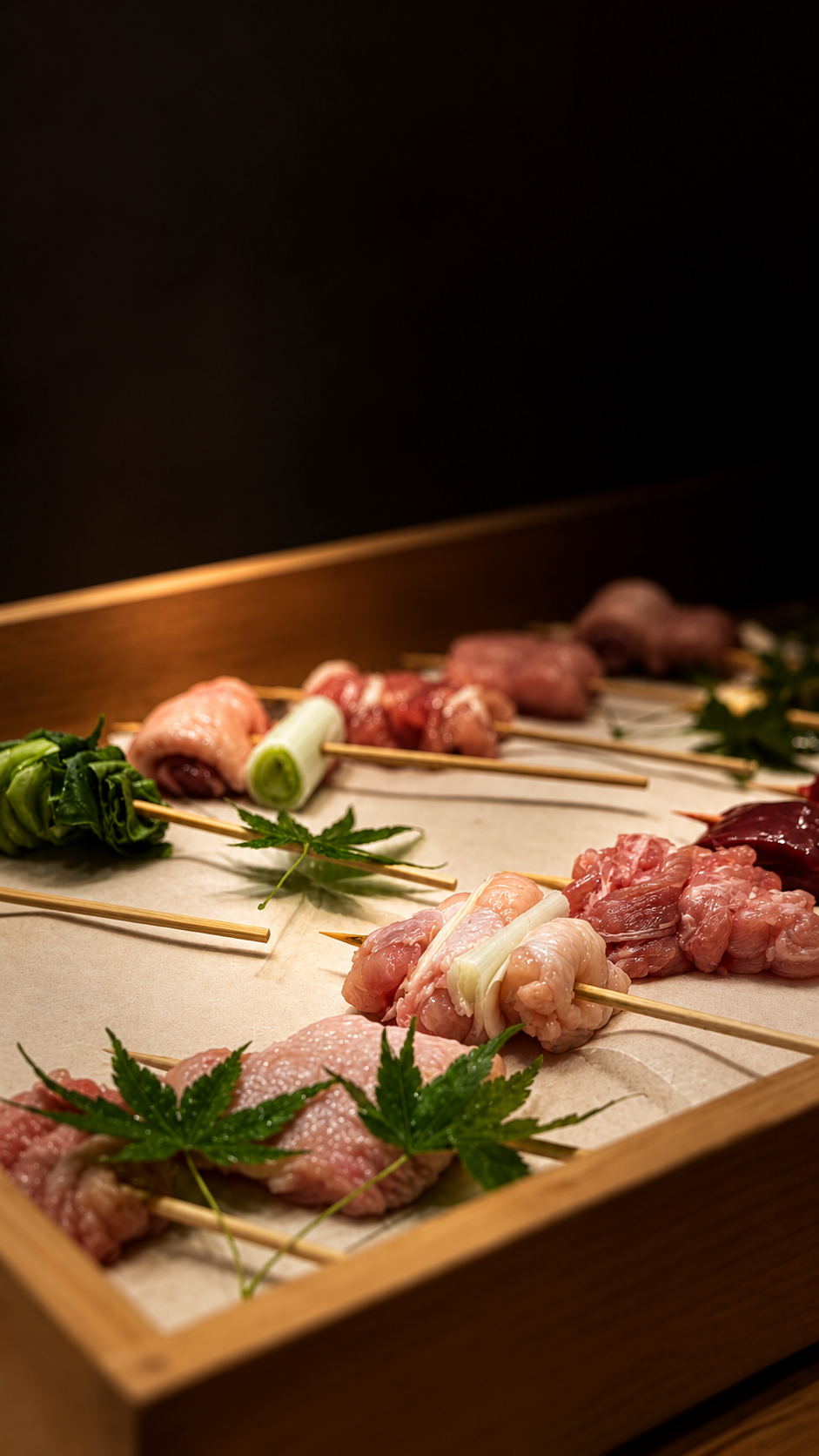 Yakitori skewers arranged on a wooden tray