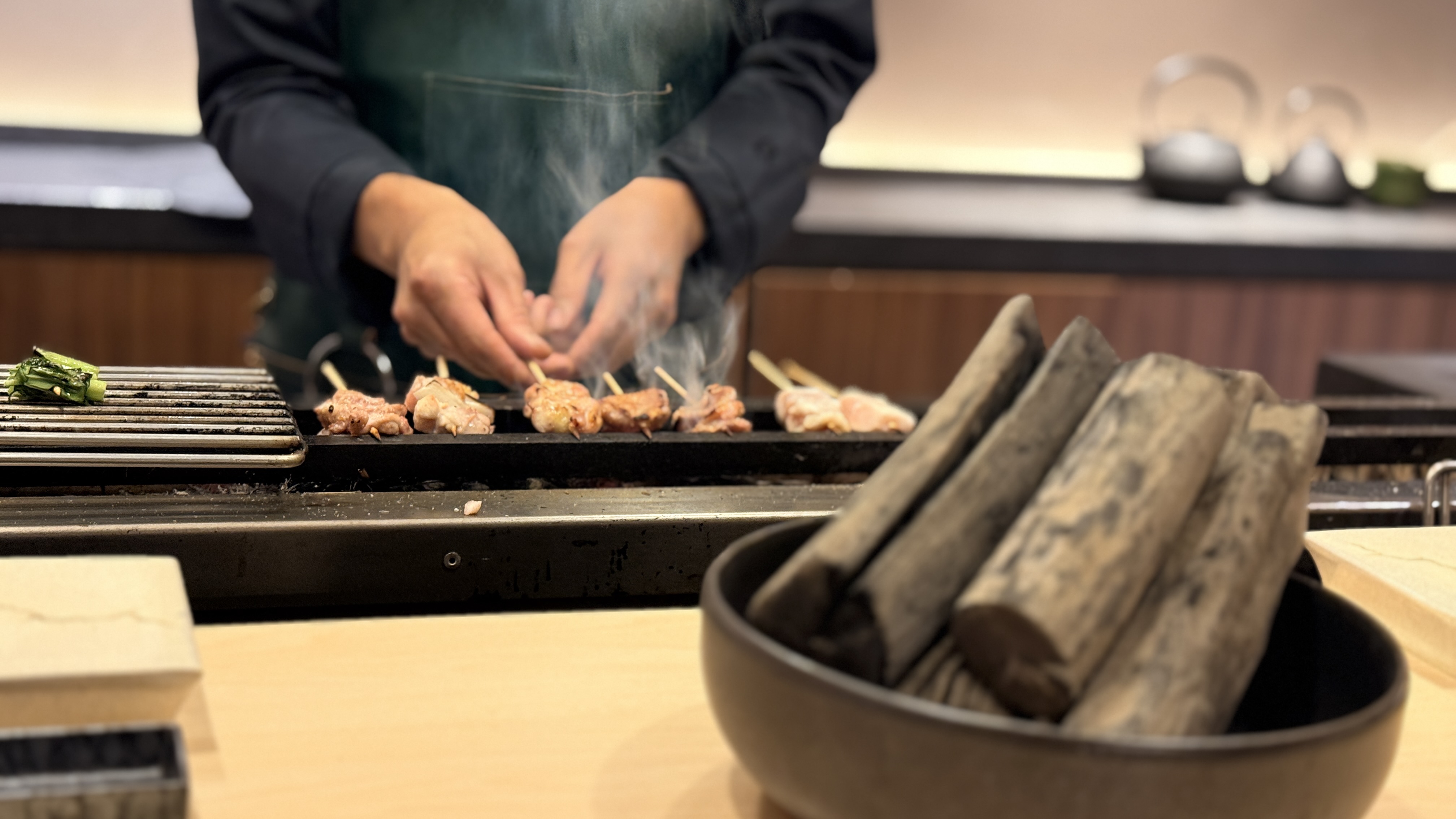 Chef preparing yakitori over binchotan charcoal
